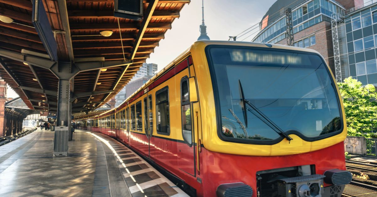 Red and yellow metro train arrives at station in Berlin